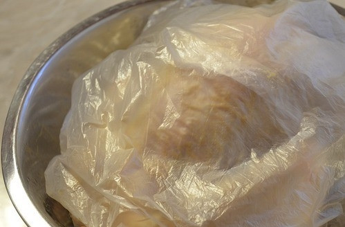 1. Этап. Курица на костре: Переверните курицу в миске грудкой вниз. Затем плотно укройте ее полиэтиленом. Подойдет обычный пакет. Оставьте мариноваться в холодильнике на пару часов, а лучше всего на всю ночь.