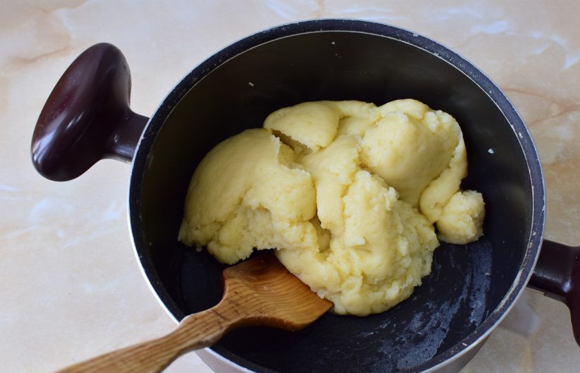 1. Этап. Французские эклеры: Тесто начнет собираться в комок. Разминая, подержите его на малом на огне 1-2 минуты. Затем дайте остыть до теплого состояния. Разминайте тесто, чтобы оно быстрее остывало.