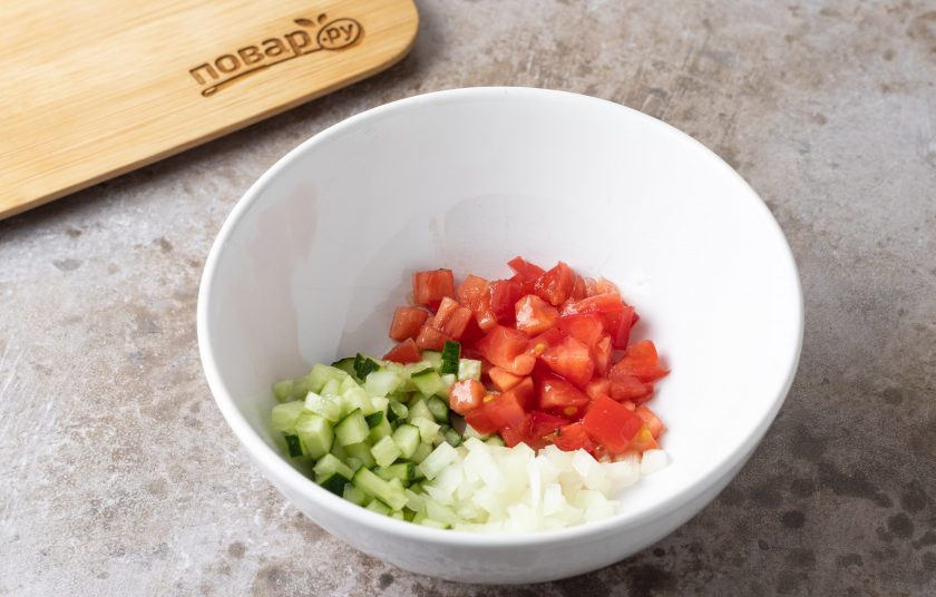 1. Этап. Запеченный авокадо: Нарежьте на мелкие кубики помидор, огурец и репчатый лук.