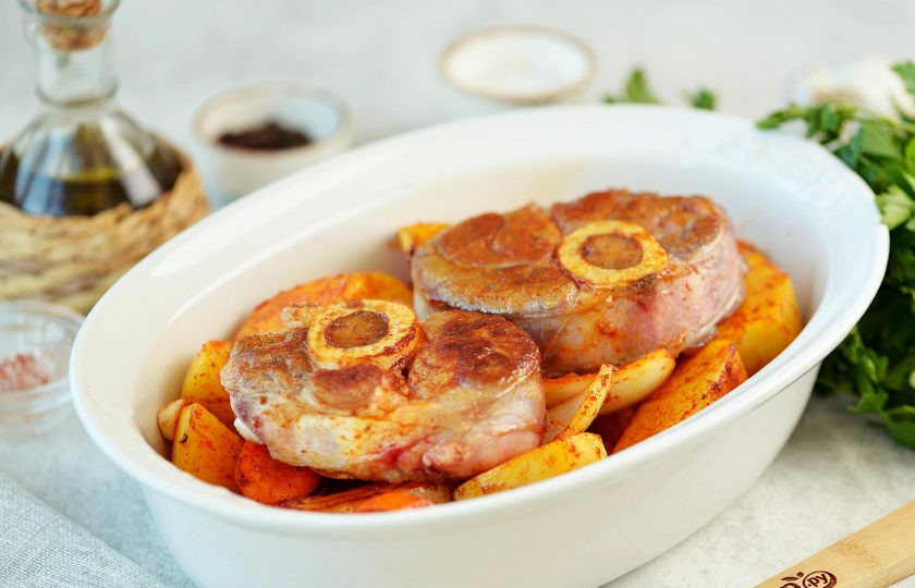 1. Этап. Телячья ножка с овощами в духовке: Переложите картофель в огнеупорную форму, сверху выложите куски телячьей ножки, слегка посолите и поперчите ее по вкусу. Накройте форму фольгой, отправьте в предварительно разогретую до 190 градусов духовку на 2 часа в режиме 