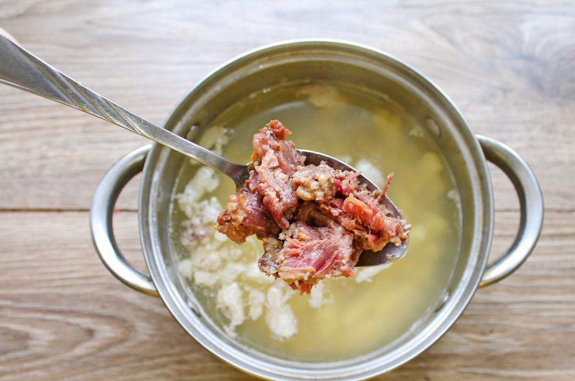 1. Этап. Суп с тушенкой из говядины: Тушенку разберите на кусочки и добавьте в кастрюлю с готовым картофелем. Перемешайте и варите еще 5-7 минут.