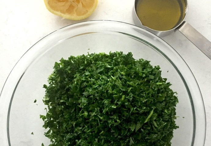 1. Этап. Салат Табуле с нутом: 3. Выложите всю зелень в миску и добавьте к ней лимонный сок, растительное масло, перемешайте.