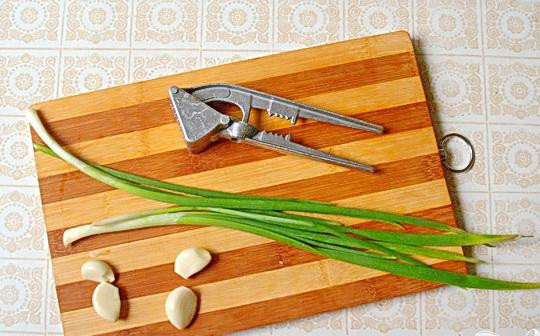 1. Этап. Деревенская похлебка из фасоли с ветчиной: 4. Через давилку пропускаем чеснок, и нарезаем совсем немного зеленого лука.