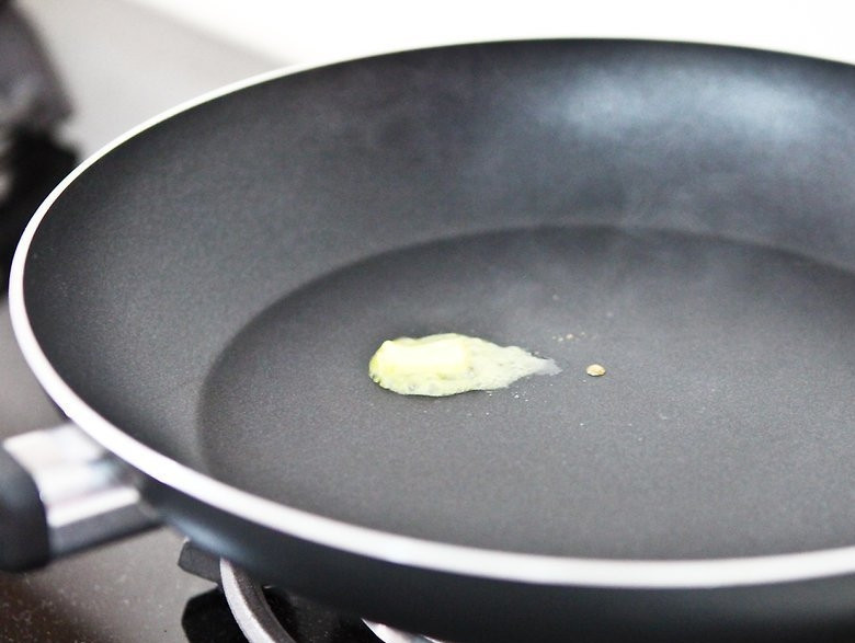 1. Этап. Оладьи из готовой смеси: 3. Разогрейте сковороду (около 5 минут). После этого добавьте небольшое количество теста, чтобы проверить ее раскаленность. Затем, убедившись, что сковорода разогрета, смажьте ее сливочным маслом.