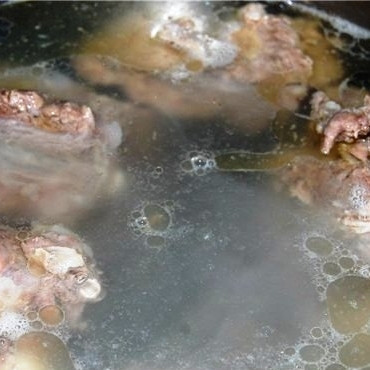 1. Этап. Суп из телячьего хвоста: Разделяем хвост на несколько частей, кладем в четырехлитровую кастрюлю. Туда же кладем 1 морковь, луковицей и половиной корня сельдерея. Заливаем холодной водой, доводим до кипения, сбавляем огонь до минимума и варим без крышки еще 4-5 часов. Примерно за полчаса до конца варки добавляем в бульон лавровый лист, соль и перец.