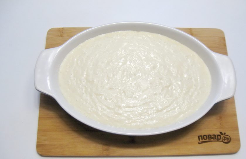 1. Этап. Запеканка из творога и пшенной каши: Форму для выпечки смажьте сливочным маслом и выложите тесто.