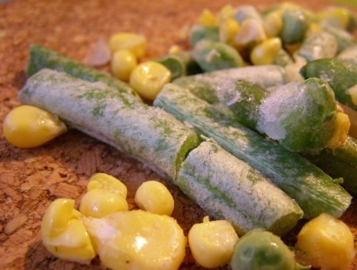 1. Этап. Кальмары, фаршированные рисом и овощами: 4. Разморозьте стручковую фасоль и кукурузу. Если у вас они свежие, фасоль просто вымойте и порежьте на небольшие части, а кукурузу отварите до готовности и снимите с початка при помощи ножа.