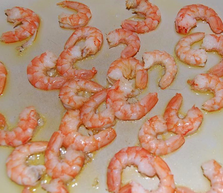 1. Этап. Вкусный низкокалорийный салат: Теперь пришло время заняться креветками. Разогрейте сковороду с оливковым маслом и выложите туда креветки. Обжарьте их втечение трёх минут. Затем выложите на бумажное полотенце, чтобы убрать лишнее масло.