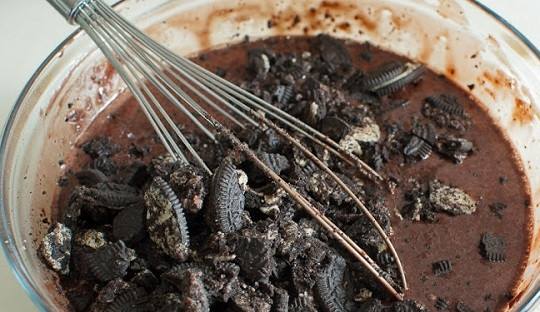 1. Этап. Шоколадный торт с печеньем: 7. Быстро взбейте все до однородной массы. Крупными кусочками поломайте печенье и добавьте в тесто. Подготовьте жаропрочную форму. Застелите ее пергаментом или смажьте маслом и присыпьте мукой.