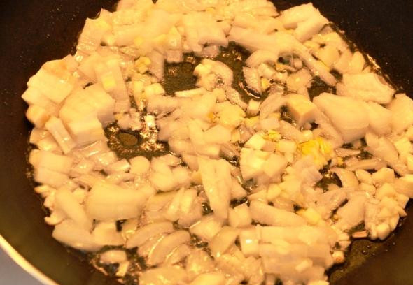 1. Этап. Кальмары жареные: Репчатый лук мелко нарезаем и обжариваем в растительном масле до прозрачности.