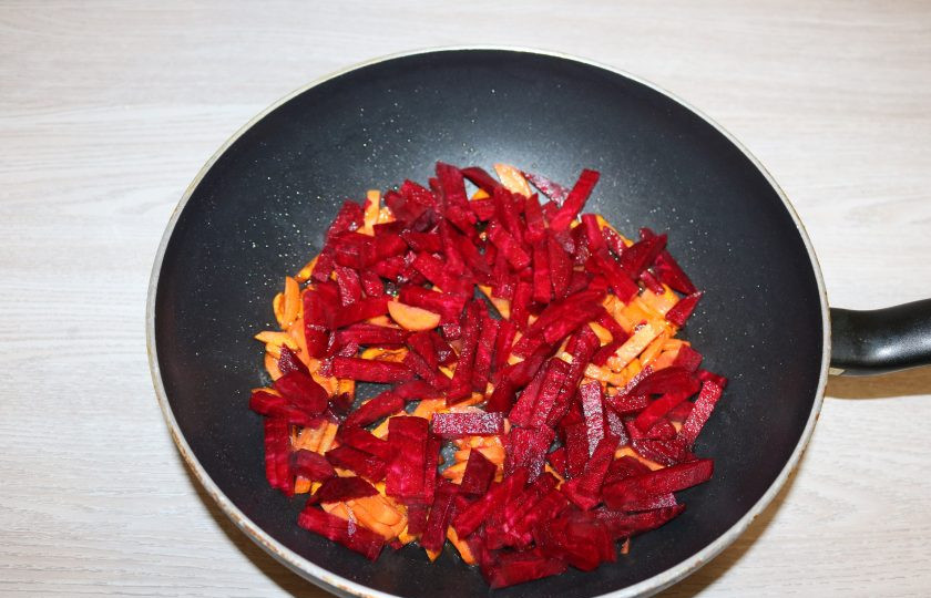 1. Этап. Борщ с карасями: Добавьте свеклу, обжаривайте вместе.