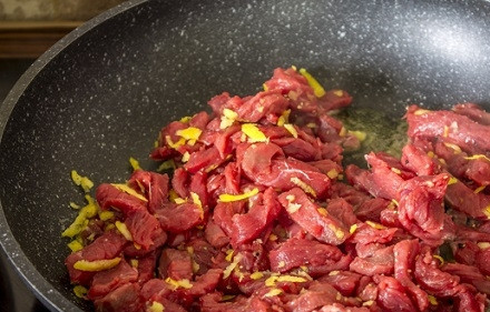 1. Этап. Говядина с луком и сметаной: На освободившуюся сковороду добавляем оставшееся масло, разогреваем и выкладываем говядину.