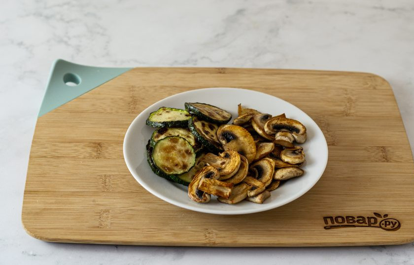 1. Этап. Вегетарианская пицца без дрожжей: В это время подготовьте начинку. Цукини и шампиньоны нарежьте ломтиками средней толщины и обжарьте с двух сторон до золотистого цвета.
