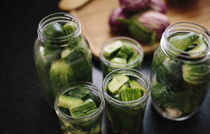 1. Этап. Огурчики по-польски: Обычно огурчики по-польски маринуются целиком, но, если ваши экземпляры слишком крупные, можете их порезать на части. В кастрюле смешайте воду, уксус и соль, доведите до кипения. Залейте огурцы в банках рассолом, оставив место примерно в сантиметр от края банки.