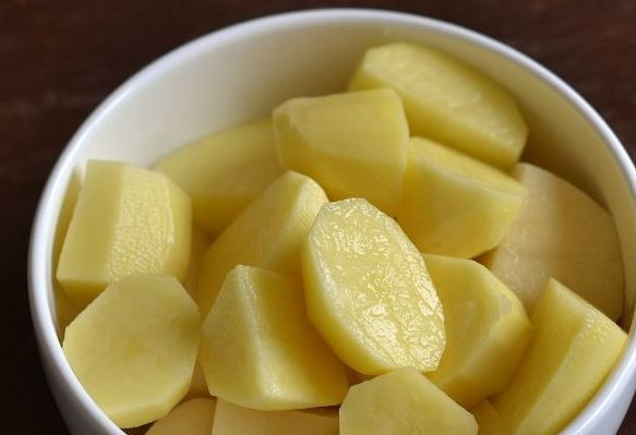 1. Этап. Тушеный картофель со свининой: Картофель почистите и вымойте. Нарежьте его на небольшие кусочки. Если картофель молодой, то его можно не очищать, а тщательно потереть щеткой под проточной водой.