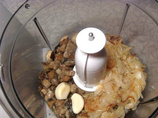 1. Этап. Икра из белых грибов: Поджаренный лук и грибы немного остужаем, а затем отправляем в чашу блендера. Туда же добавляем чеснок. Всё измельчаем. По своему вкусу вы можете сделать икру в виде пюре или же оставить ее в слегка зернистом состоянии.