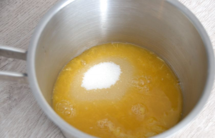 1. Этап. Апельсиновый мармелад на агар-агаре: Влейте в сотейник вторую половину сока, всыпьте сахар, добавьте агар-агар вместе с соком, в котором он был замочен. Нагрейте до закипания, проварите при помешивании 5-7 минут с момента закипания.