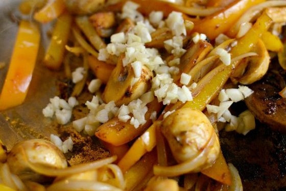 1. Этап. Каджунская паста с курицей: 5. Когда грибы станут мягкими, добавьте чеснок и влейте вино. Готовьте 1 минуту.