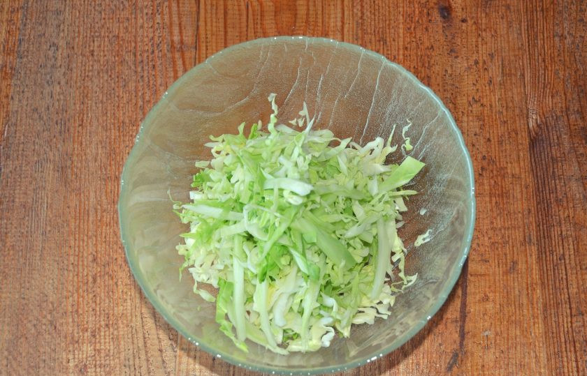 1. Этап. Салат с капустой, огурцами и кукурузой: В глубокий салатник нашинкуйте капусту.