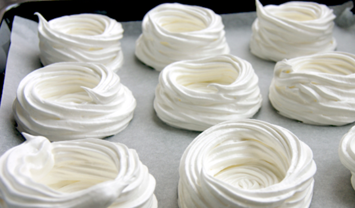 1. Этап. Безе с ягодами: Перекладываем белки в пекарский пакет. Выдавливаем на противень, застеленный бумагой для выпечки. Должно получиться 10 корзиночек.