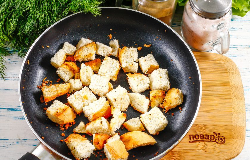 1. Этап. Салат Цезарь диетический: Ломтики багета нарежьте кубиками и поджарьте на сковороде без масла примерно 1-2 минуты, остудите. При остывании хлеб начнет хрустеть.