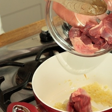 1. Этап. Афганский плов: Нагреть масло в достаточно большой кастрюле, чтобы вместить все ингредиенты. Добавить крупно нарезанный лук и жарить 2 минуты, после чего добавить баранину, нарезанную на крупные куски (примерно 6 см стороной). Жарить 15 минут, перемешивая.