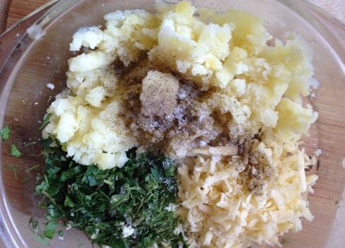 1. Этап. Чуду: Для начинки отварим картофель в кожуре, затем очистим его и разомнем. Сыр натираем на терке, зелень мелко нарежем. Добавим соль по вкусу и молотый перец. Перемешаем.