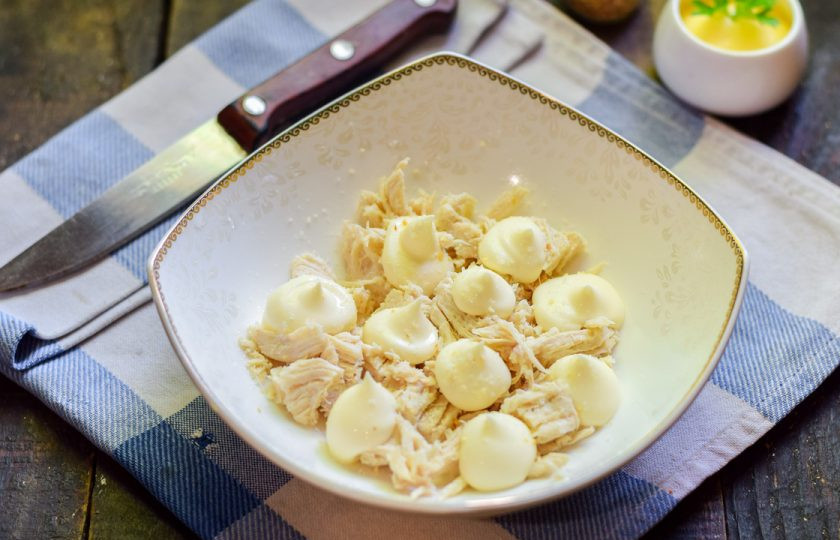 1. Этап. Салат Царский с ананасами: Филе выложите в салатник первым слоем, смажьте немного майонезом.