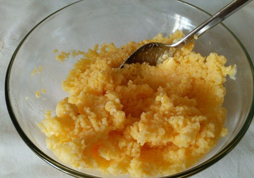 1. Этап. Кукурузно-сырная запеканка: Сварите кукурузную крупу в подсоленной воде (соотношение 1:2) в течение 15-20 минут. Для этого удобно использовать крупу в варочных пакетах. Переложите готовую кукурузную кашу в подходящую ёмкость, дайте ей слегка остыть.