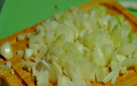 1. Этап. Салат с кальмарами и яйцами: 3. Очистите и измельчите кубиками лук. Ошпарьте его кипятком.