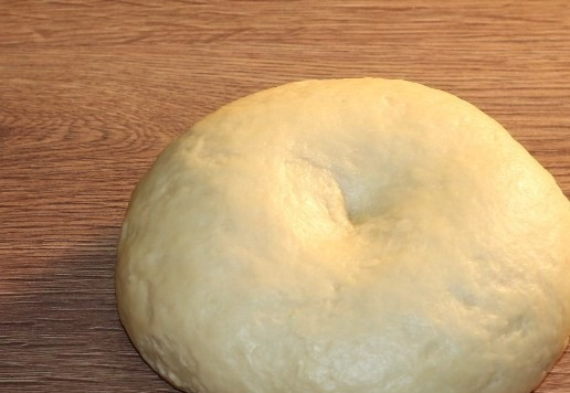 1. Этап. Пирожки с яблочной начинкой: 9. Вмешиваем 2 ст. л. растительного масла в тесто, собираем в ком и округляем.