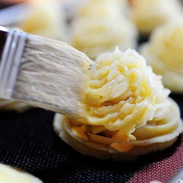 1. Этап. Картофель Герцогиня: 5. Взбить 1 яйцо с 1/2 чашки густых сливок и аккуратно смазать полученной смесью картофель с помощью кисти. Это будет сделать намного проще, если вы предварительно поставите картофель в холодильник примерно на полчаса.