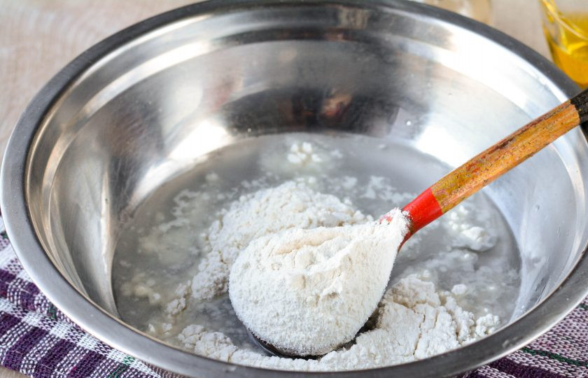 1. Этап. Жареные пирожки на заварном тесте: Влейте кипяток в миску, всыпьте соль, добавьте 100 грамм муки.
