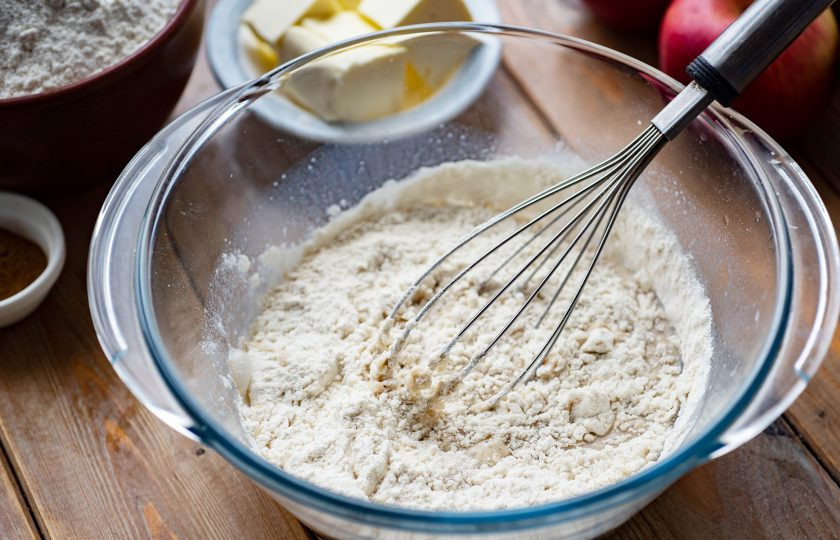 1. Этап. Булочки с яблоком и корицей из дрожжевого теста: Добавьте 4-5 ст.л. муки, венчиком все перемешайте до получения однородной смеси.