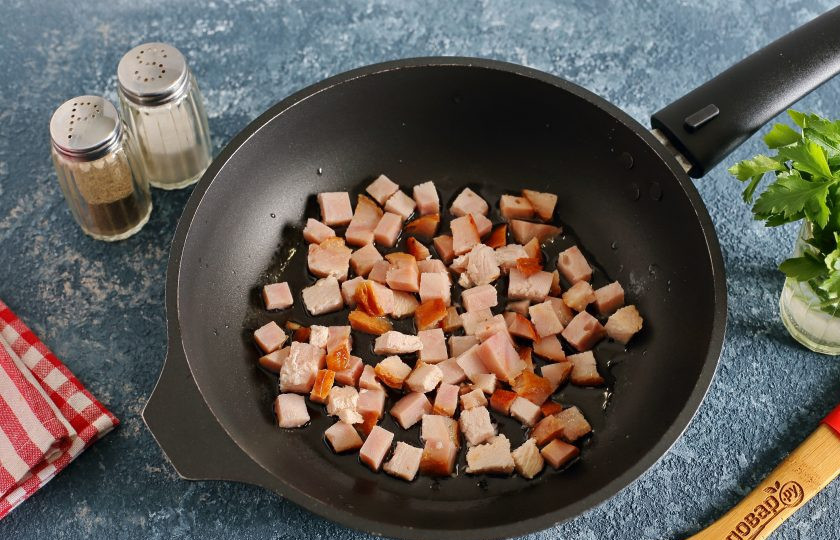 1. Этап. Яичница с бужениной: На разогретую сковороду с маслом выложите буженину, нарезанную кубиками.