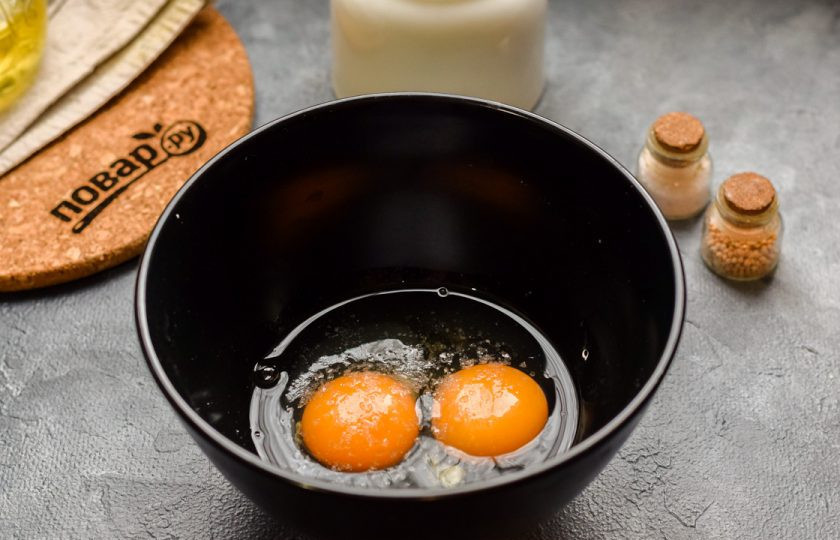 1. Этап. Быстрый пирог с колбасой: Вбейте в миску яйца, добавьте соль и перец.