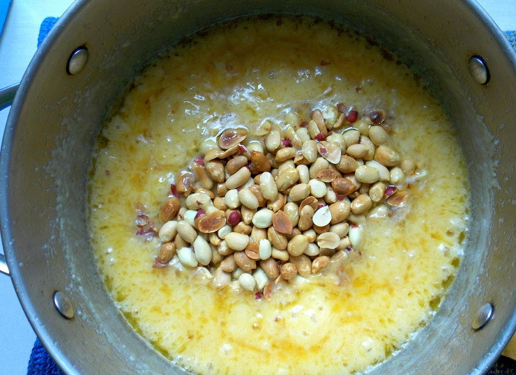 1. Этап. Домашний щербет с арахисом: Всыпьте орехи, перемешайте и снимите с огня.
