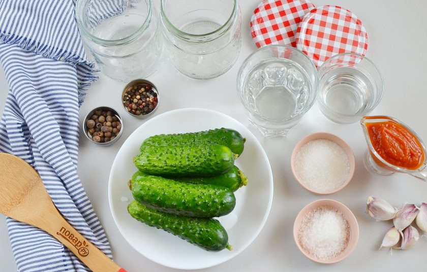 1. Этап. Огурцы в томатном соусе: Для консервации понадобятся огурцы, соль, сахар, столовый уксус, чеснок, томатный соус, вода, чёрный и душистый перец горошком.