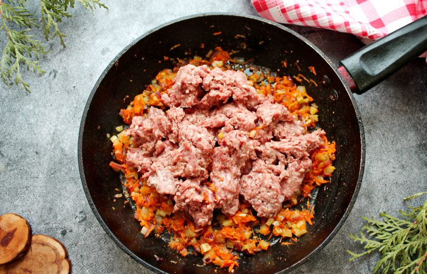 1. Этап. Паста Болоньезе классическая: Говядину сполосните и порежьте на кусочки, прокрутите через мясорубку с мелкой решеткой. Выложите фарш в обжаренные овощи и перемешайте. Посолите и обжаривайте все в течение 15 минут, перемешивая и разбивая большие кусочки.