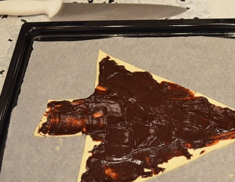 1. Этап. Пирог Елочка: 4. А дальше все очень просто: застелите пергаментом противень, выложите свверху пласт теста. Смажьте его шоколадом.