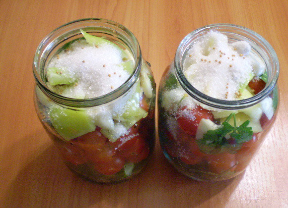 1. Этап. Закатка овощного ассорти: На дно банки выложите листочки. Потом овощи в любом порядке. Сверху насыпьте сахар и соль. Я добавила чуточку горчицы сухой (в зернах) для остроты.