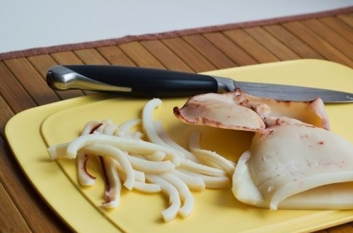 1. Этап. Салат из кальмаров вкусный: 4. В подсоленной воде отварите тушку кальмара (3 минуты в кипятке). Остудите и нарежьте тонкой соломкой. Вкрутую отварите яйца.