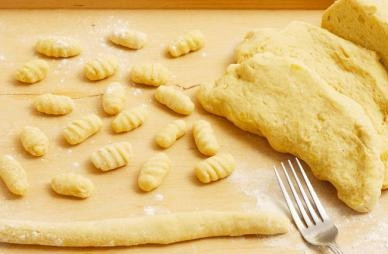 1. Этап. Картофельные кнедлики: Получившееся тесто делим на части. Каждую часть раскатываем в колбаску толщиной с палец и нарезаем на кусочки 3 см. Зубчиками вилки сделаем на каждом кусочке бороздки для красоты.