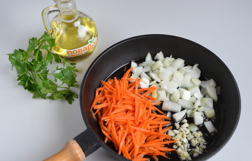 1. Этап. Чечевица с шампиньонами: 3. Измельчите овощи: лук порежьте кубиками, морковь натрите на крупной терке, чеснок пропустите через пресс или нарежьте кубиками. Обжарьте овощи до полуготовности на растительном масле.