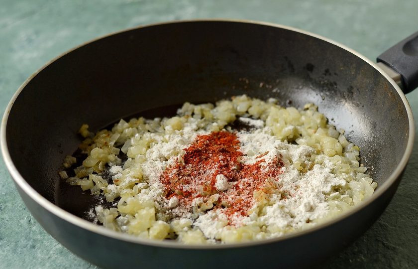 1. Этап. Луковая подлива для котлет: Добавьте муку, перемешайте. Посолите, поперчите, приправьте паприкой и мускатным орехом. Еще раз перемешайте.