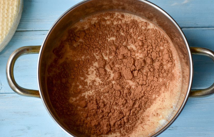 1. Этап. Шоколадно-вафельный торт: Влейте в кастрюлю молоко, добавьте какао.