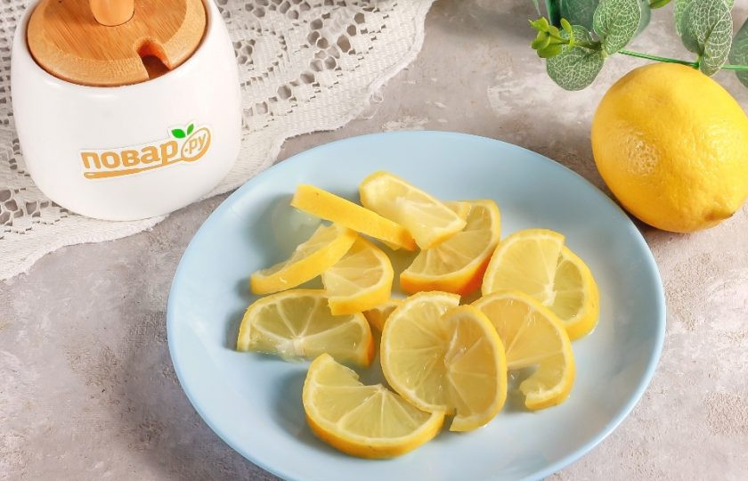 1. Этап. Протертый лимон с сахаром через мясорубку: Вскипятите воду в чайнике и ошпарьте все лимоны в течение 1 минуты. Таким образом из фруктов можно удалить горечь. Разрежьте каждый плод на части, затем на ломтики и удалите косточки.