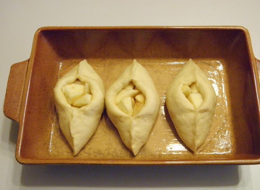 1. Этап. Расстегаи с яблоками: Разложите расстегаи на смазанные противни на расстоянии и оставьте подходить. Через 20 минут смажьте взбитым яйцом и отправьте в духовку. Температура — 180 градусов, время запекания — 20-25 минут.