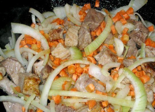 1. Этап. Свинина с болгарским перцем: Затем добавляем к свинине лук, нарезанный полукольцами, и морковь, нарезанную на небольшие кубики. Перемешиваем и продолжаем обжаривать до золотистого цвета лука.