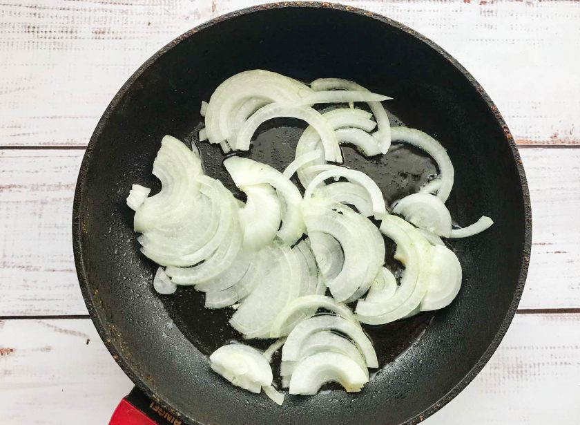 1. Этап. Тушеная брюссельская капуста с картошкой: Репчатый лук очистите от шелухи, нарежьте полукольцами и обжарьте на хорошо разогретой сковороде с растительным маслом.